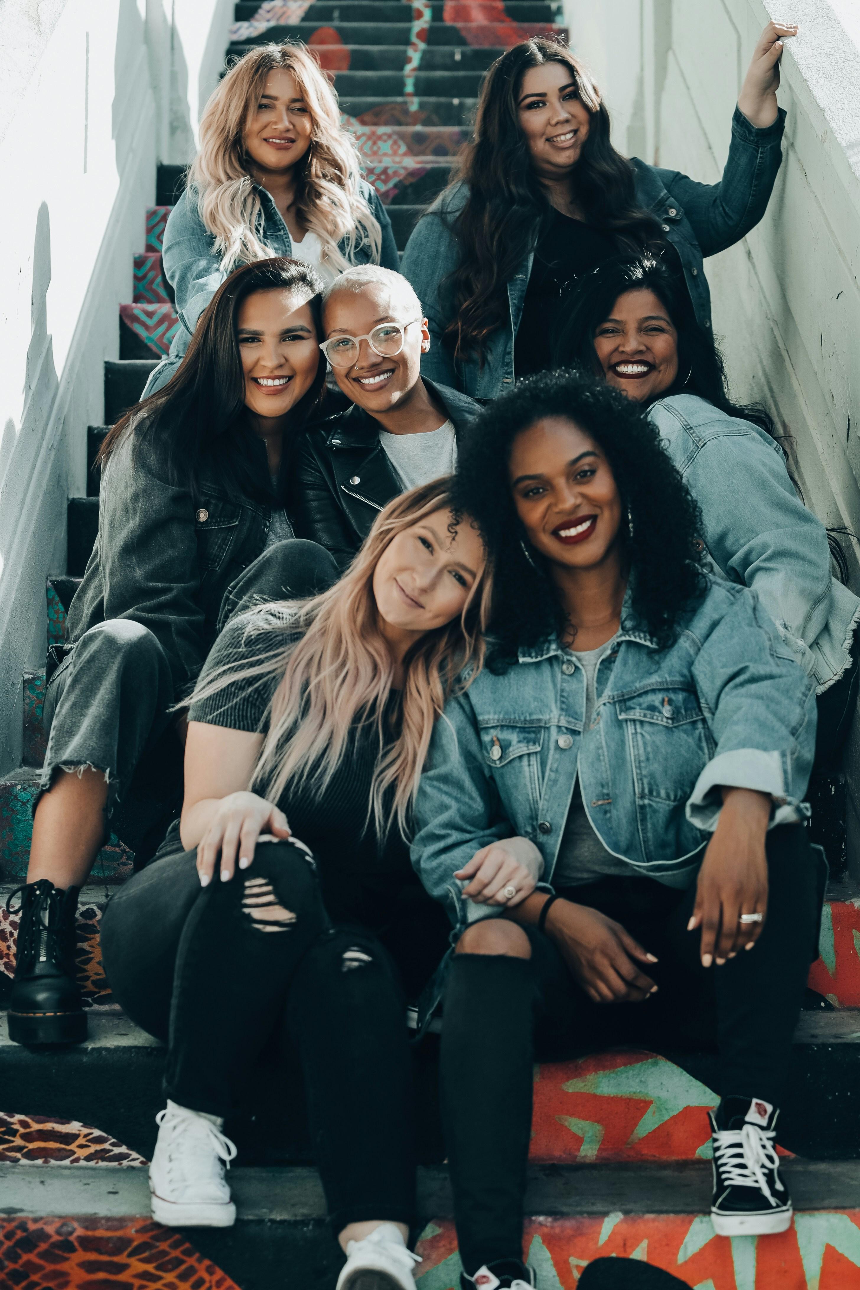 A diverse group of women together, smiling